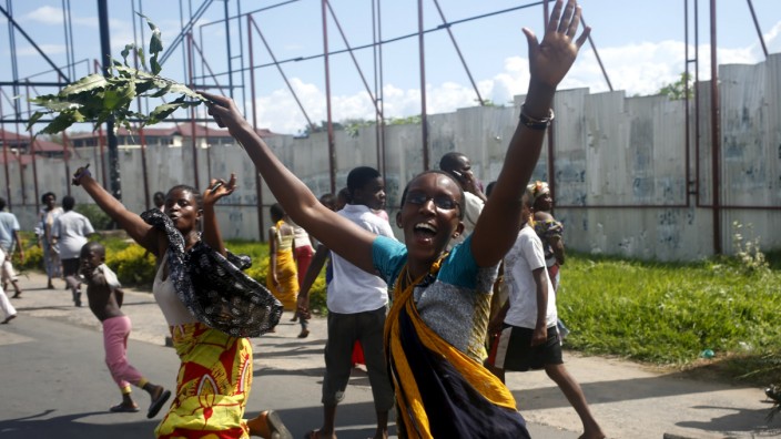 People celebrate in a street in Bujumbura
