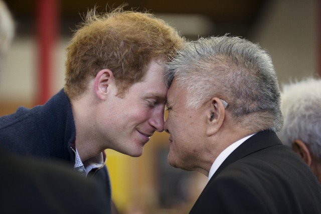 Britain's Prince Harry exchanges a hongi greeting with local elder Hiria Hape as he visits a spinal rehabilitation unit in Auckland