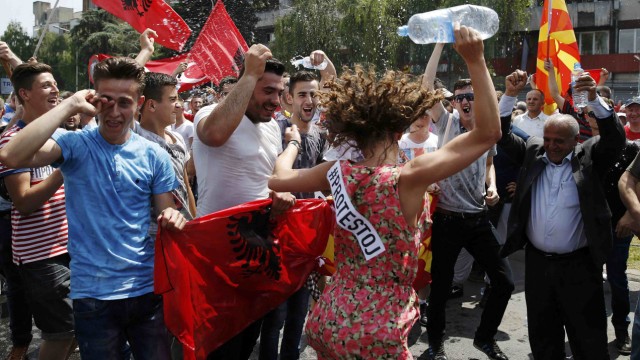 Anti-government protesters dance during a demonstration in Skopje