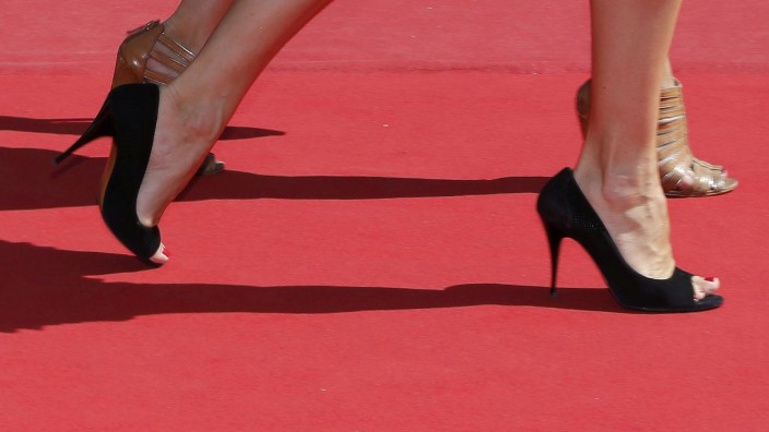 Guests walk on the red carpet as they arrive for the screening of the film 'La loi du marche' in competition at the 68th Cannes Film Festival in Cannes