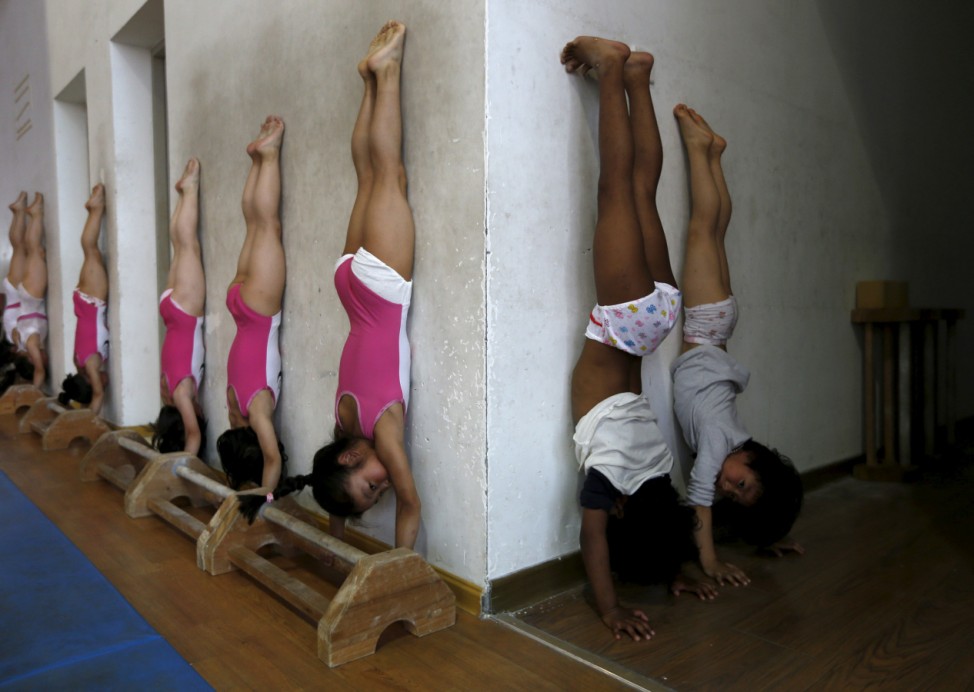 Students practice at the gymnastics hall of a sports school in Jiaxing