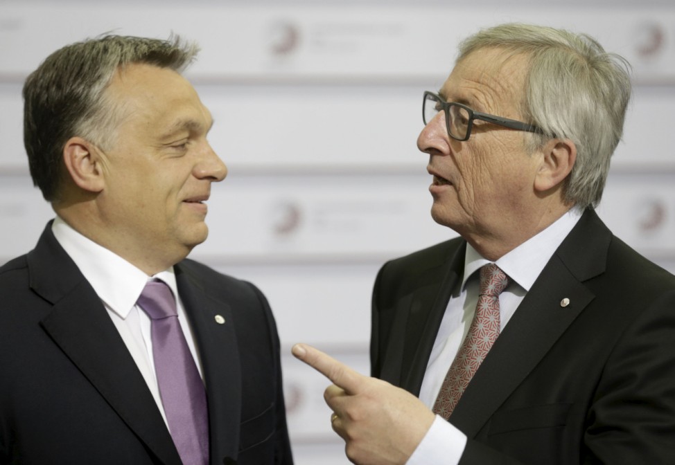 European Commission President Juncker speaks to Hungary's Prime Minister Orban before the Eastern Partnership Summit session in Riga