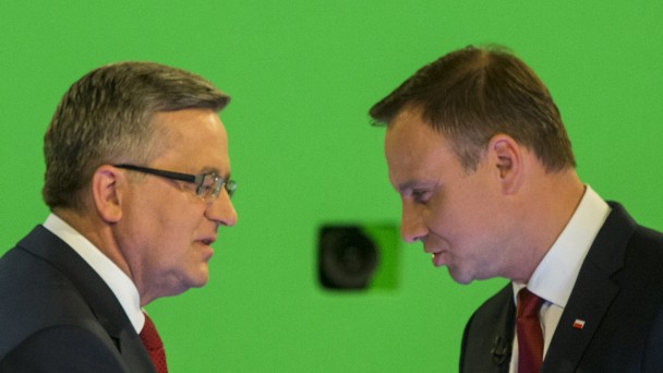Komorowski and Duda shake hands during their face-to-face televised debate at the TVN studio in Warsaw
