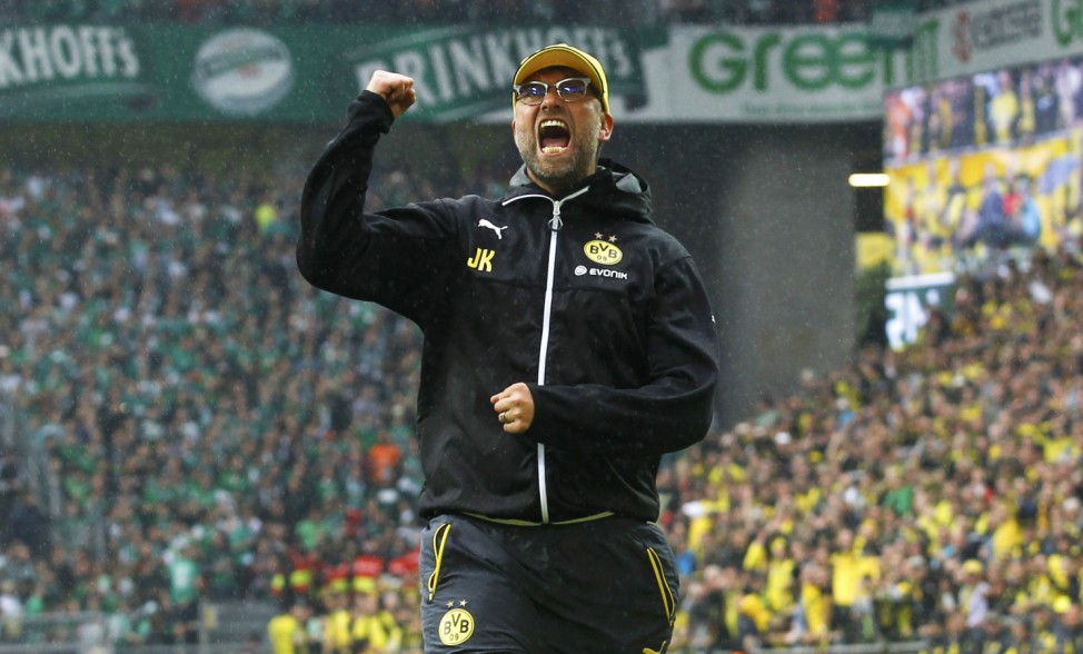 Borussia Dortmund's coach Klopp celebrates with his supporters after their team's first division Bundesliga soccer match against Werder Bremen in Dortmund