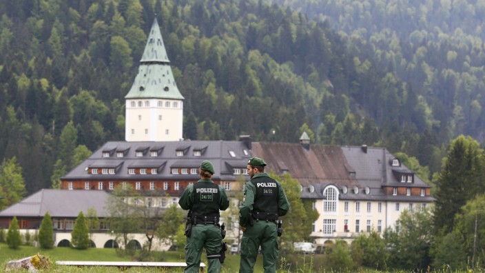 Members of the German riot police unit 'Bayerische Bereitschaftspolizei' observe the hotel castle Elmau in Kruen