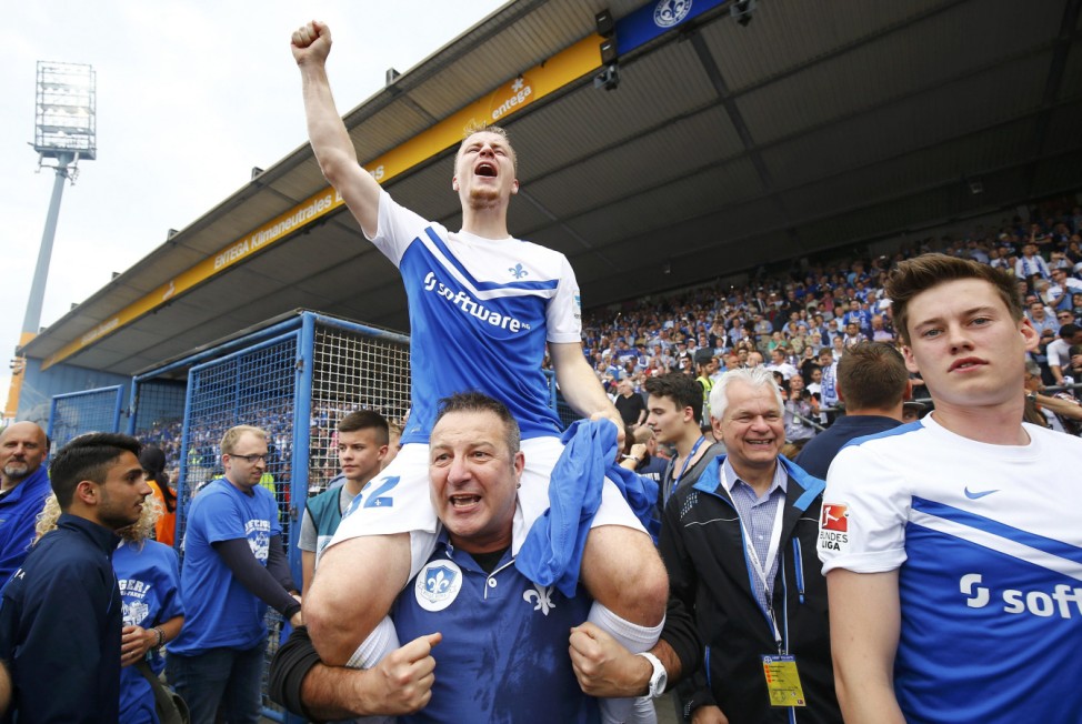 Damstadt's Holland celebrates with fans and teammates after winning their German Bundesliga second division soccer match against Sankt Pauli in Darmstadt