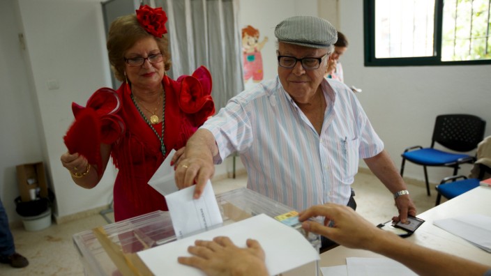 A man votes at a polling station during regional and municipal elections in El Rocio village, southern Spain