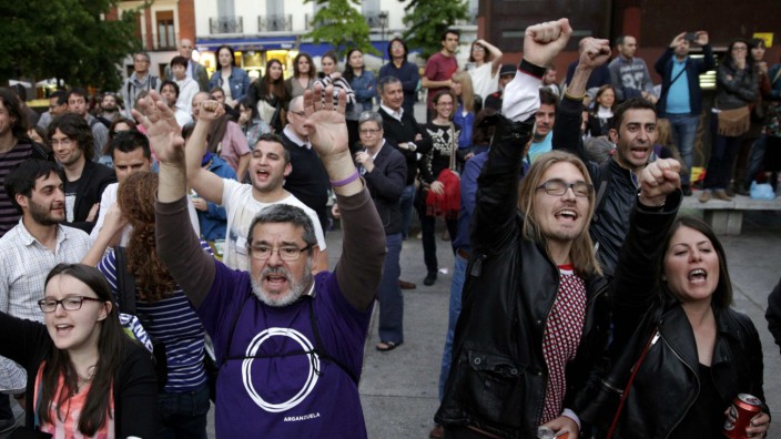 Supporters of Podemos (We can) react at the party's meeting area after the regional and municipal elections in Madrid