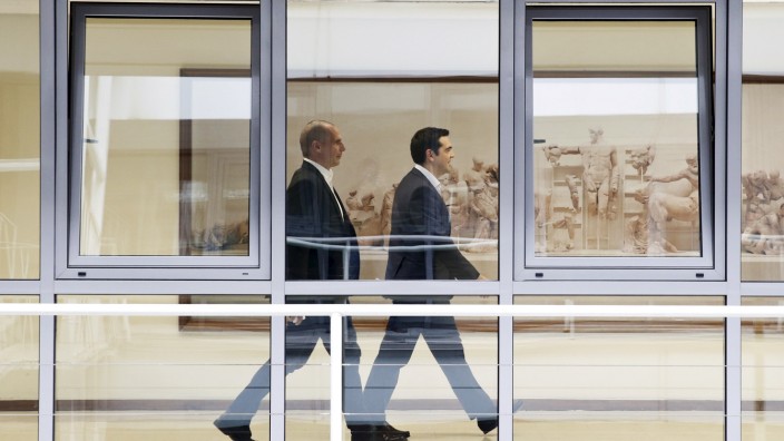 Greek PM Tsipras and Finance Minister Varoufakis leave a meeting at the Finance ministry in Athens