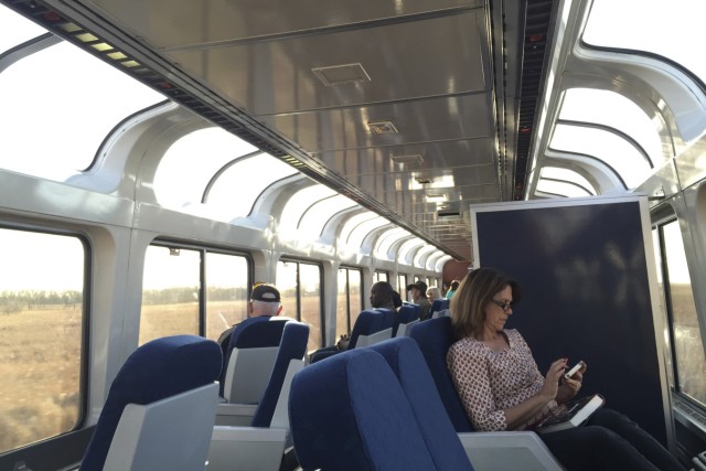 Passengers sit in the upper deck of a lounge car on Amtrak's Empire Builder as it travels between Minneapolis and Williston, North Dakota