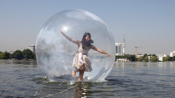 Woman tests Walk Wather Ball on the Alster lake in Hamburg