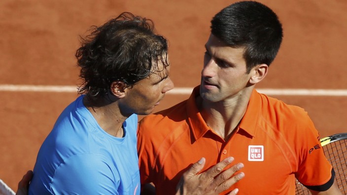 Novak Djokovic of Serbia shakes hands with Rafael Nadal of Spain after winning their men's quarter-final match during the French Open tennis tournament at the Roland Garros stadium in Paris