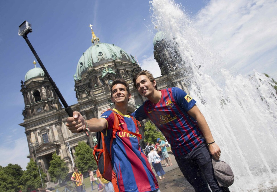 Barcelona fans pose for a selfie in front of the Dome Cathedral in Berlin