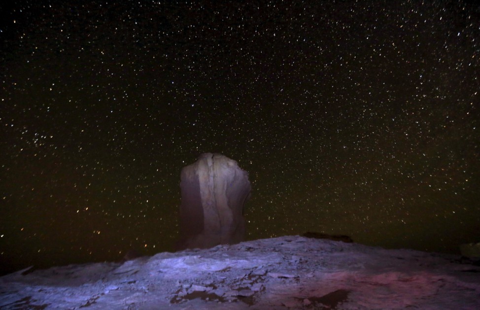 A huge number of stars are seen in the night sky over rocks in the White Desert north of the Farafra Oasis
