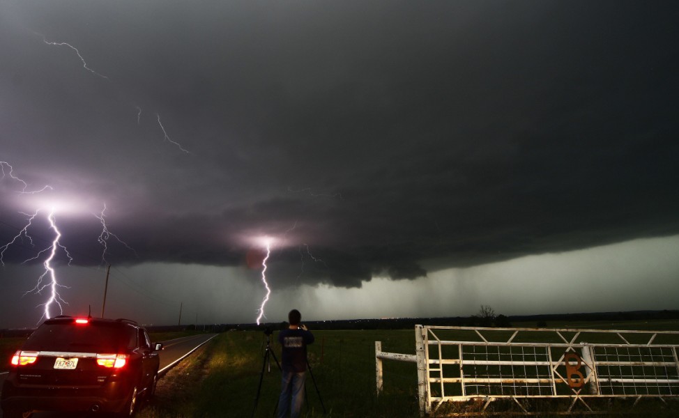 Cloud to ground lightning strikes near storm chasers during a tornadic thunderstorm in Cushing