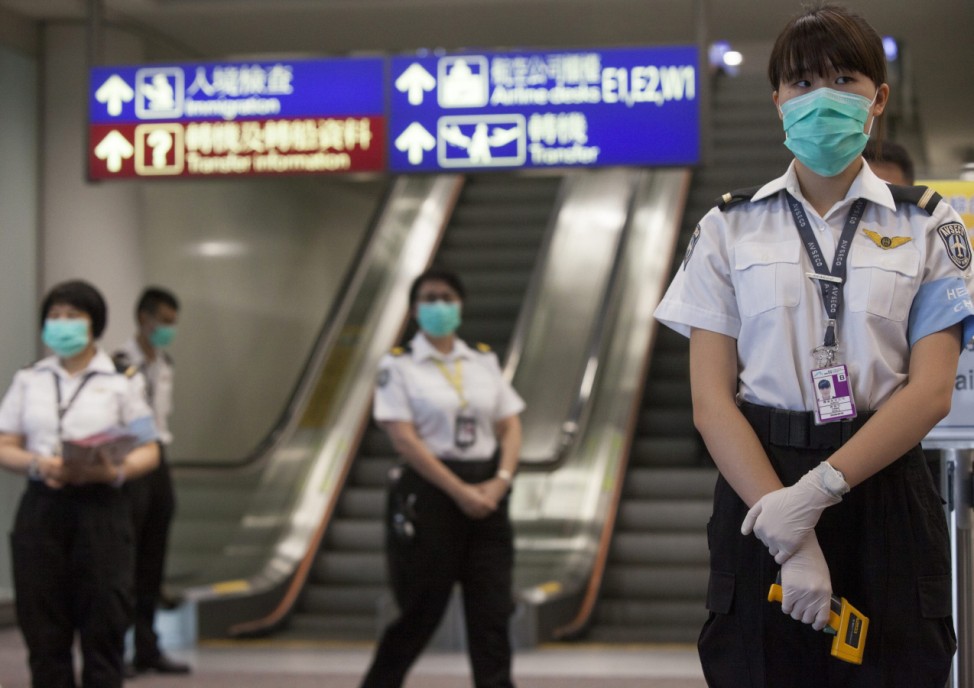 Health workers at Hong Kong airport guard against MERS