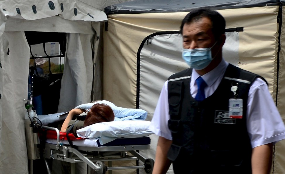 A woman, who is believed to be infected with Middle East Respiratory Syndrome (MERS), lies on a stretcher in a quarantine area set up in a hospital in Seoul