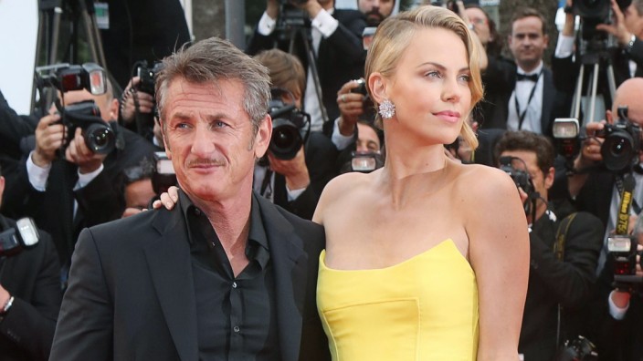 Sean Penn and Charlize Theron arrive on the red carpet before the screening of the film Mad Max Fu