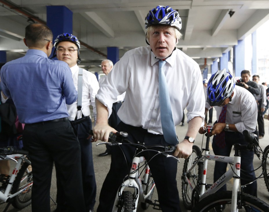 London's Mayor Johnson prepares to cycle through the city during an official visit to Kuala Lumpur