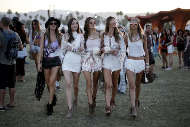 Victoria's Secret model Alessandra Ambrosio of Brazil (C) walks through the Coachella Valley Music and Arts Festival with friends, in Indio