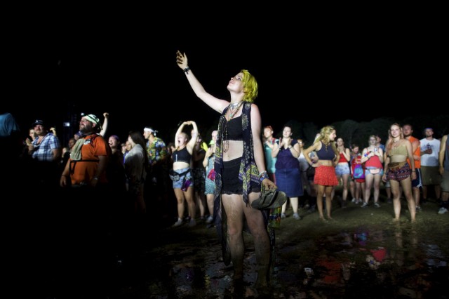 A woman points towards the sky during the performance by McCartney at the Firefly Music Festival in Dover