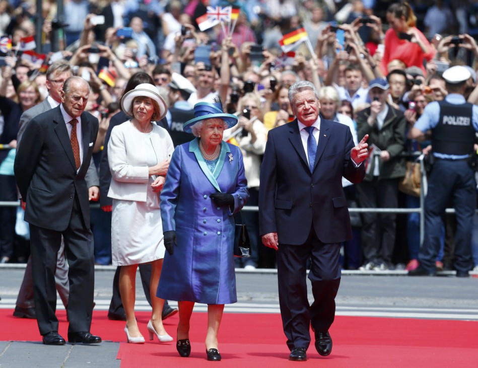 Britain's Queen Elizabeth and German President Gauck are followed by Prince Philip and Gauck's partner Schadt as they walk from St. Paul's Church to Roemer in Frankfurt