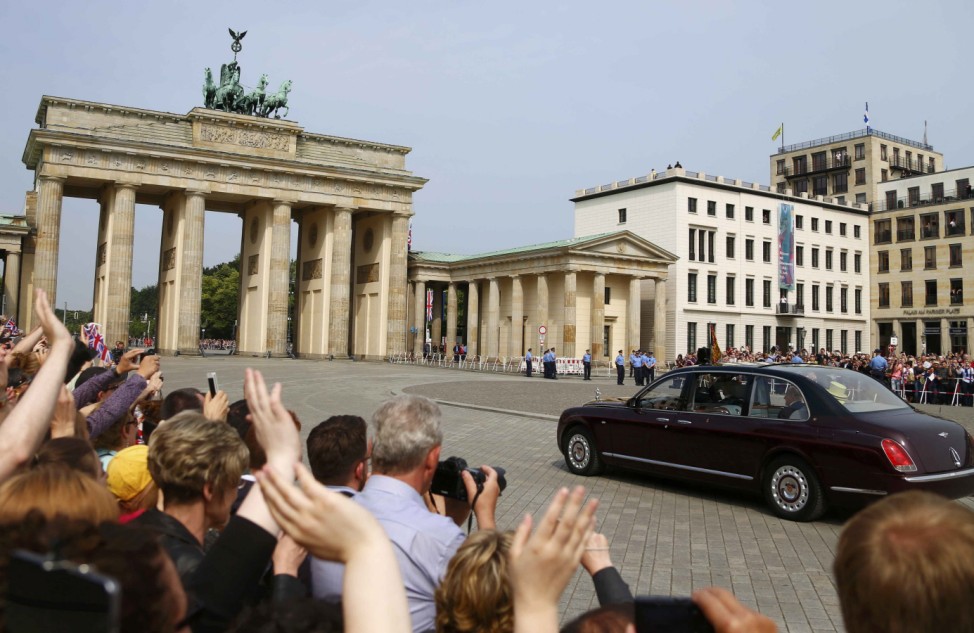 Britain's Queen Elizabeth and Prince Philip are driven through the Brandenburg Gate in Berlin