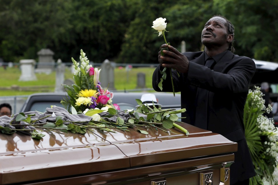 Gary Washington stands over the casket of his mother, Ethel Lance, as she is buried at the Emanuel African Methodist Episcopal Church cemetery in North Charleston