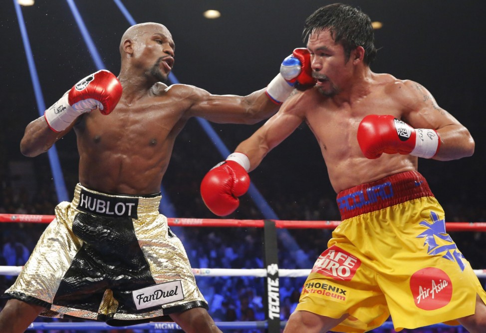 File photo of Mayweather, Jr. landing a left to the face of Pacquiao in the 11th round during their welterweight title fight in Las Vegas