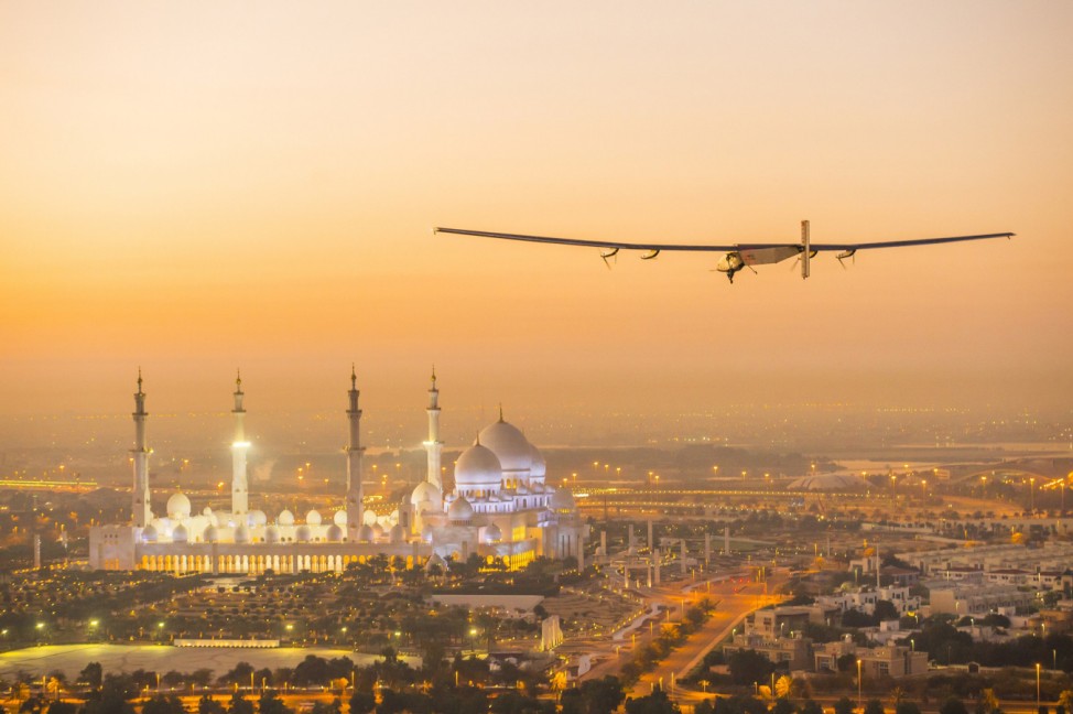The Solar Impulse 2, a solar-powered plane, flies over the Sheikh Zayed Grand Mosque in Abu Dhabi