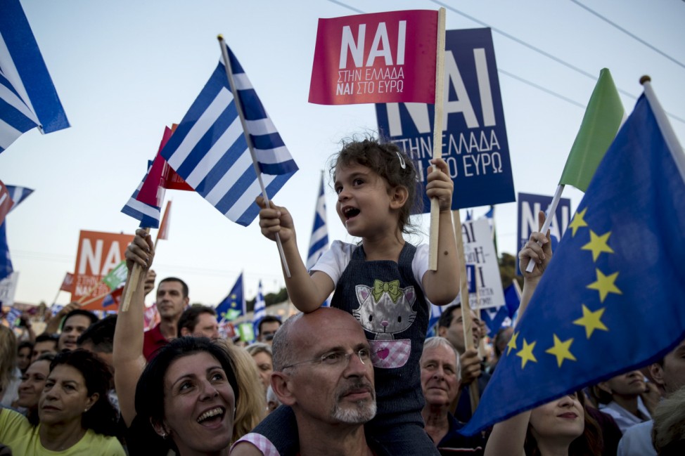 A 'Yes' supporter wave Greek flags during a pro-Euro rally at the Panathenean stadium in Athens