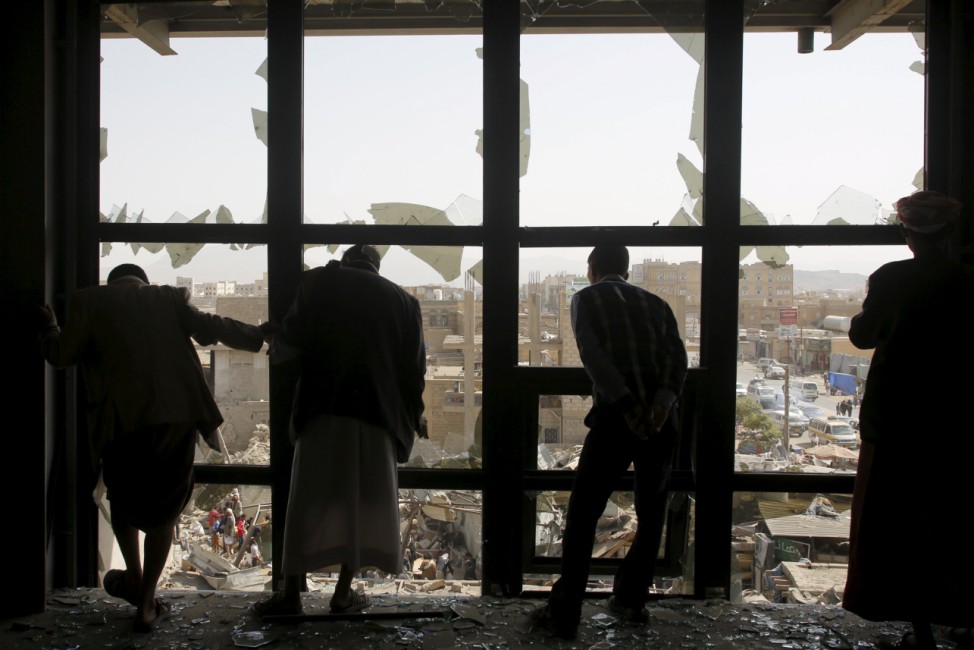 People look at a marketplace after it was hit by a Saudi-led air strike in Yemen's capital Sanaa
