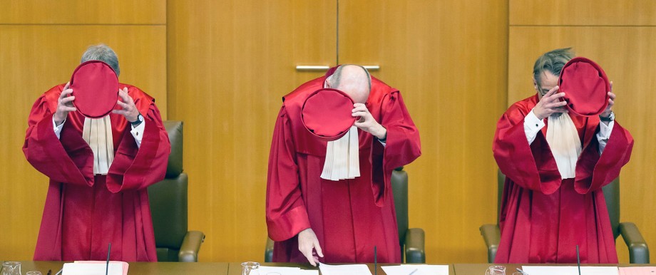 Judges Eichberger, vice-president of Germany's Constitutional Court Kirchhof and Gaier take off their hats after the announcement of the verdict on an inheritance law file at Germany's Federal Constitutional Court (Bundesverfassungsgericht) in Karlsruhe