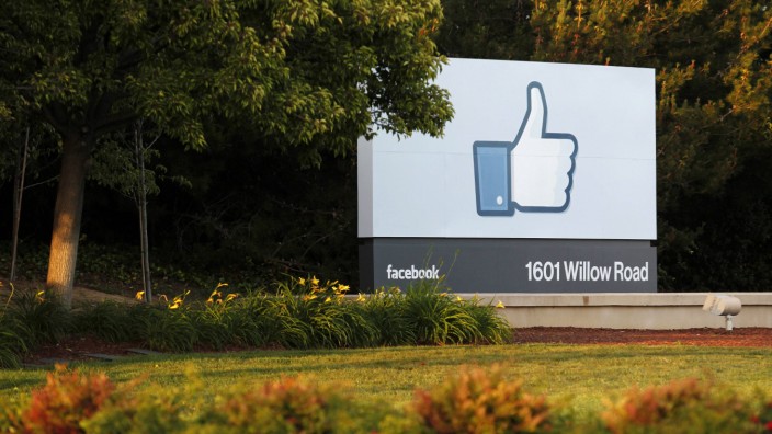 The sun sets on the entrance sign at Facebook's headquarters in Menlo Park the night before its IPO launch
