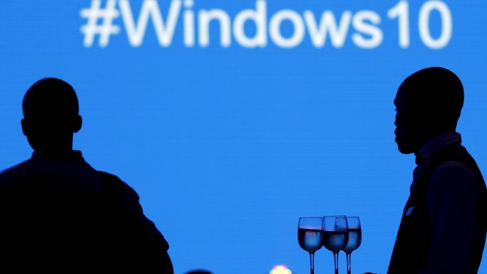 A waiter serves a Microsoft delegate during the launch of the Windows 10 operating system in Kenya's capital Nairobi