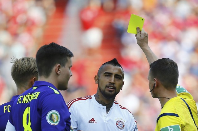 Vidal of Bayern Munich receives a yellow card by the referee during their German cup (DFB Pokal) first round soccer match against fifth division club FC Noettingen in Karlsruhe