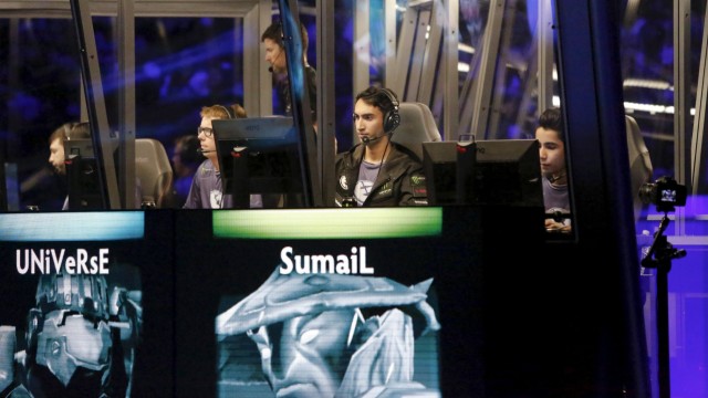 Members of Evil Geniuses compete in the Grand Finals of The International Dota 2 Championships at Key Arena in Seattle, Washington