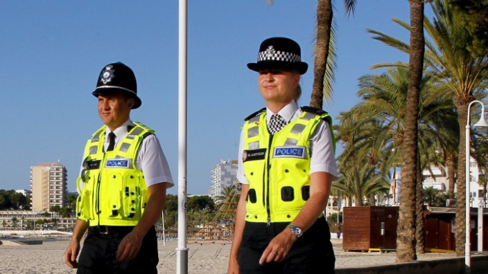 British police officers patrol with Spanish civil guard officers along the seaside of Magaluf