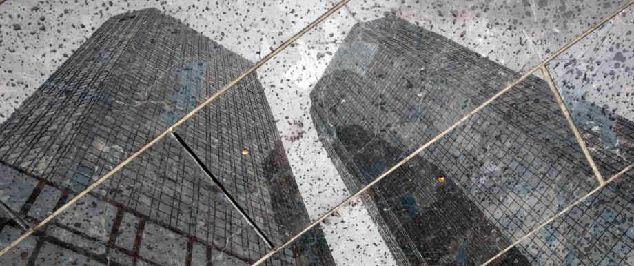 The headquarters of the Deutsche Bank are reflected in the polished floor, in Frankfurt