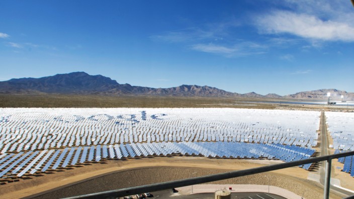 Katie Kukulka, an information officer with the California Energy Commission, takes photos during a tour of the Ivanpah Solar Electric Generating System in the Mojave Desert near the California-Nevada border