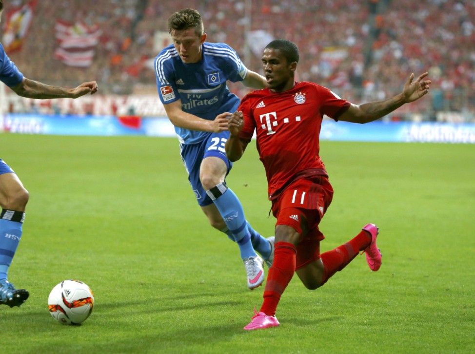 Bayern Munich's Costa is challenged by Hamburger SV's Gregoritsch in Bundesliga soccer match in Munich