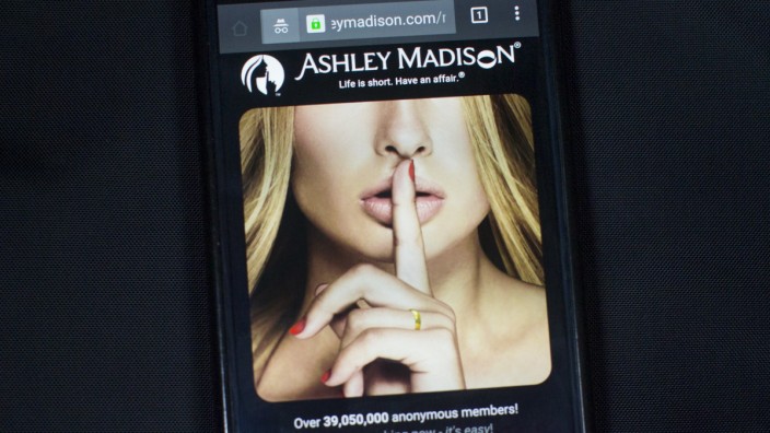 A photo illustration shows the Ashley Madison website displayed on a smartphone in Toronto