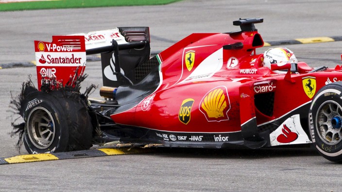 Ferrari Formula One driver Sebastian Vettel of Germany steers his car to safety area after tyre failure during the Belgian F1 Grand Prix in Spa-Francorchamps