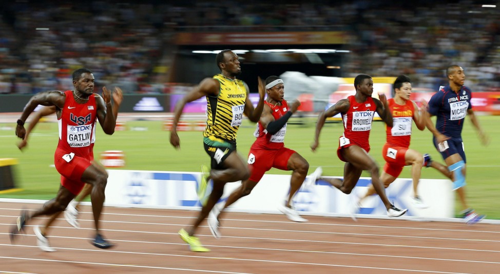 Gatlin of the U.S. and Bolt of Jamaica run to the finsih line in the men's 100 metres final during the 15th IAAF World Championships at the National Stadium in Beijing