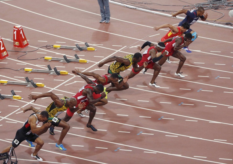 Athletes compete at the start of the men's 100 metres final during the 15th IAAF World Championships at the National Stadium in Beijing