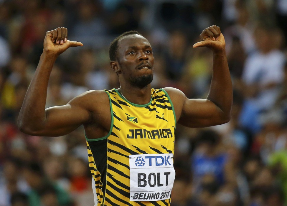 Usain Bolt of Jamaica (C) prepares to start in the men's 100 metres semi-final at the 15th IAAF World Championships at the National Stadium in Beijing