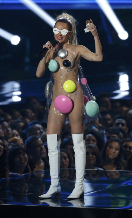 Show host Miley Cyrus speaks on stage at the 2015 MTV Video Music Awards in Los Angeles