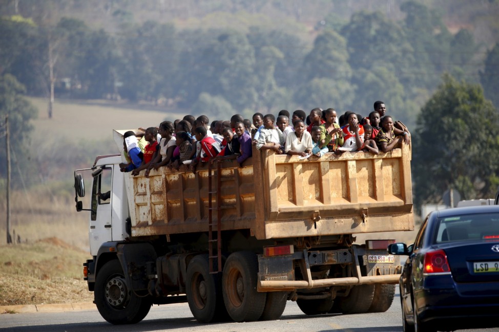 Maidens riding in the back of a dump truck arrive ahead of the last day of the Reed Dance at the Ludzidzini royal palace in Swaziland