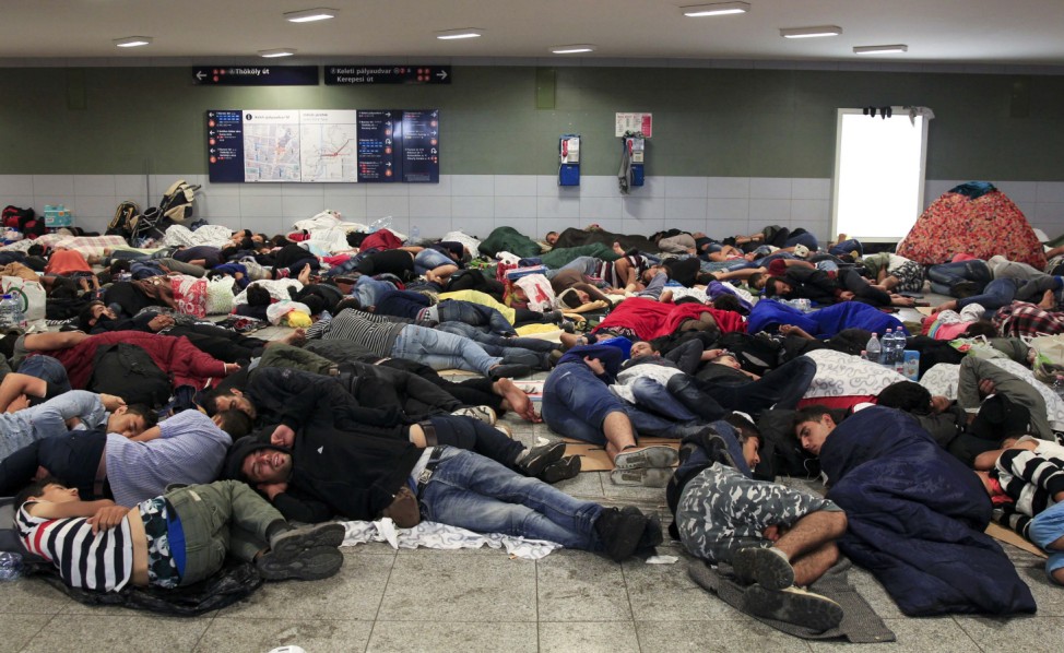 Migrants sleep near the Keleti railway station in Budapest