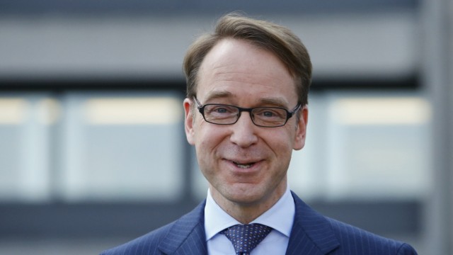 Weidmann, chief of Germany's Bundesbank, smiles as he arrives for the yearly news conference in Frankfurt